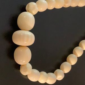 Antique necklace descending ivory colored beads.